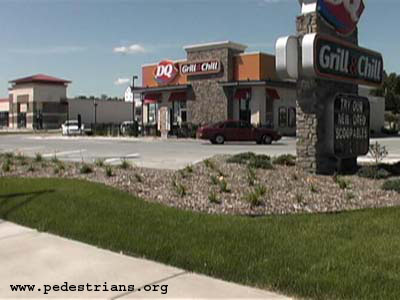 Plantings, no walkway, between sidewalk and restaurant.