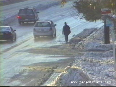Pedestrian in snowy street.